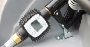 Flow meter installed on a diesel tank showing fuel flow measurement system for agricultural use