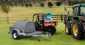 UTV with diesel fuel pod on the back tray alongside a diesel tank trailer used for farm fuel management