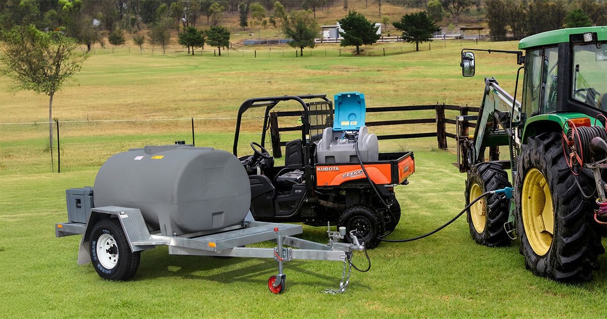 UTV with diesel fuel pod on the back tray alongside a diesel tank trailer used for farm fuel management