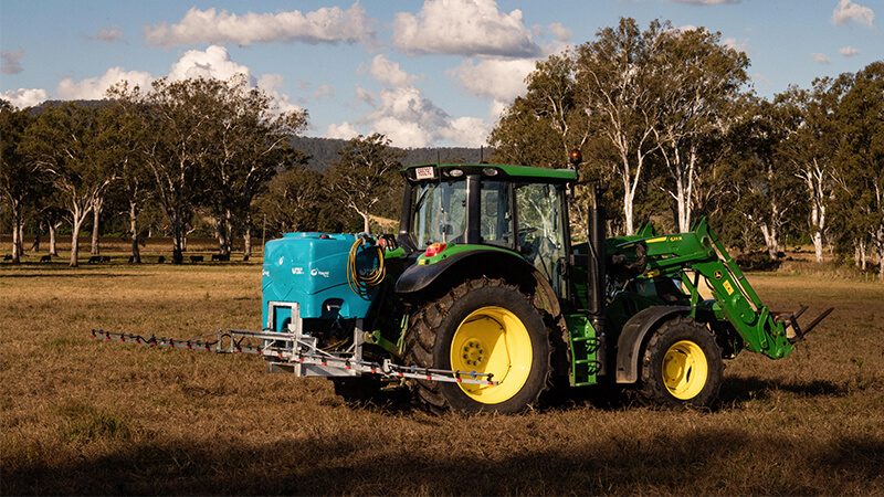Rapid Spray FieldLink 3-Point Linkage Sprayer attached to a John Deere tractor operating in a rural field for broadacre spraying applications.