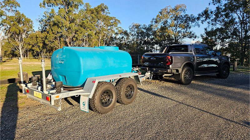 Rapid Spray water cart trailer towed by a black Ford Ranger ute
